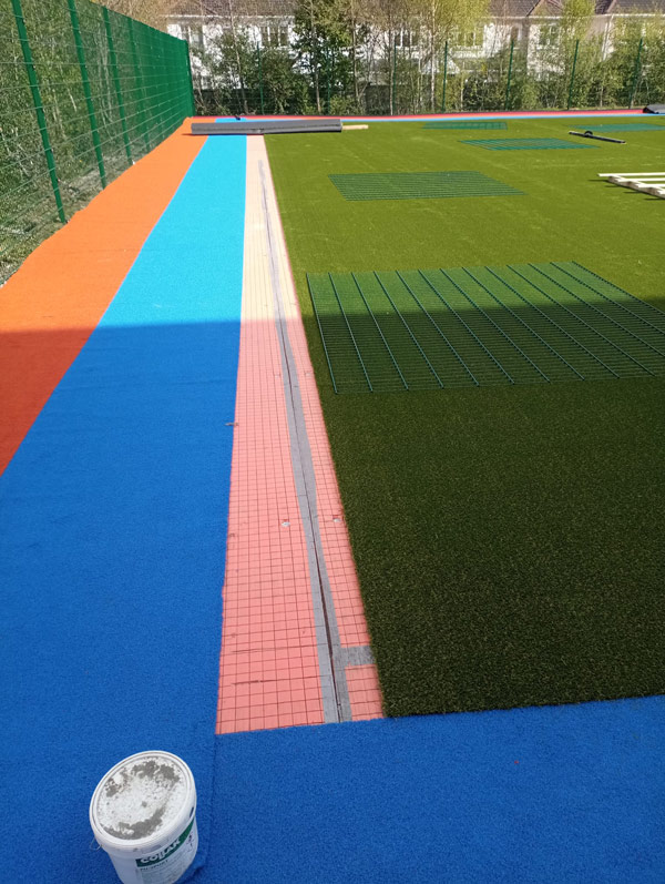 image of school playground installation of artificial grass